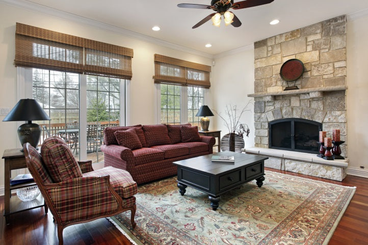 den with stone fireplace and vintage area rug